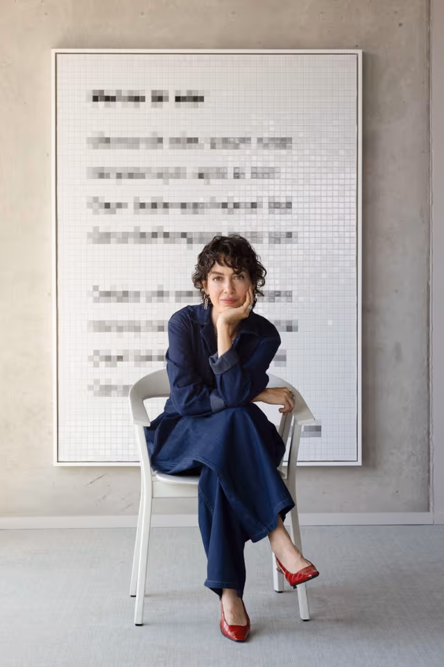 The artist Esra Gülmen in front of one of her mosaic works, photo: Burak Studio