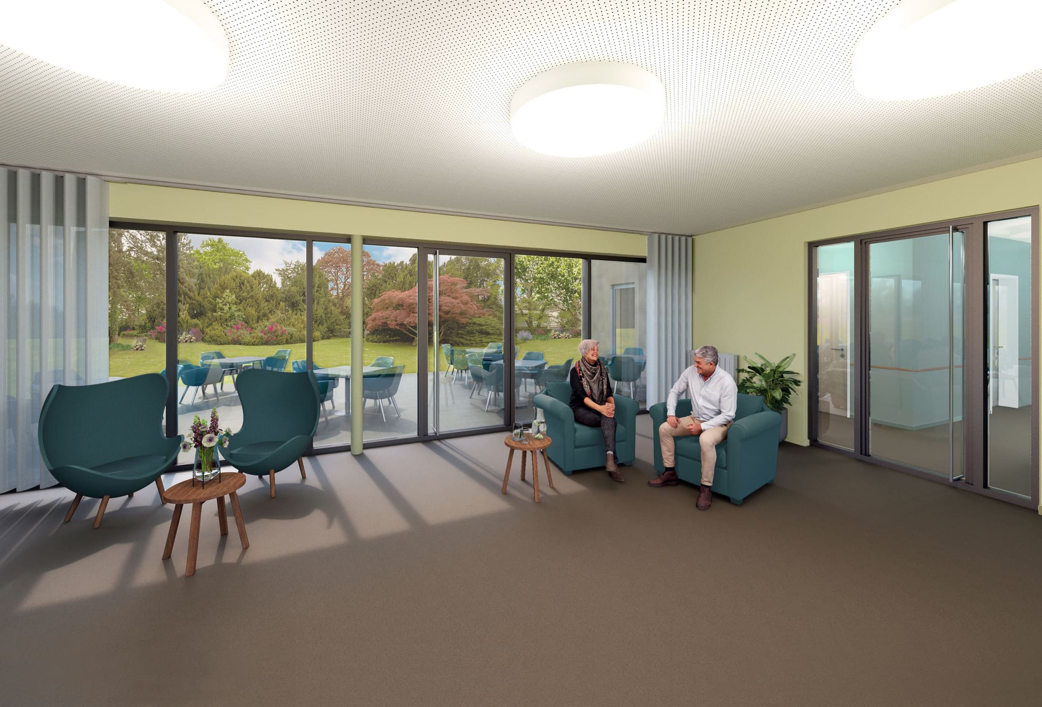 Communal room with teal armchairs and side tables, full-height sliding windows onto a terrace with chairs and tables, lawn beyond