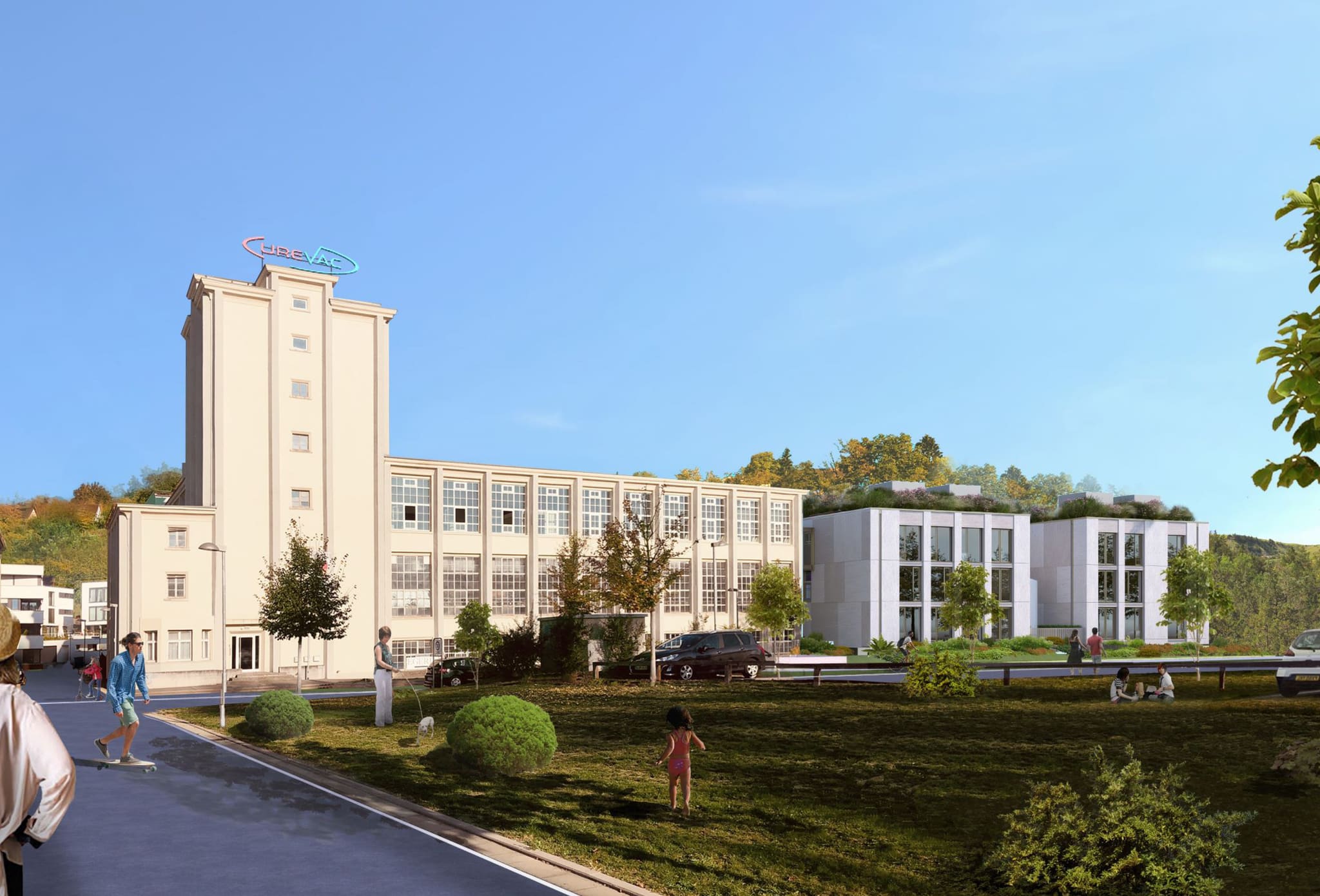 Visualisation: pale factory building with tower and gridded windows, a three-storey new build with planted roof, meadow in front
